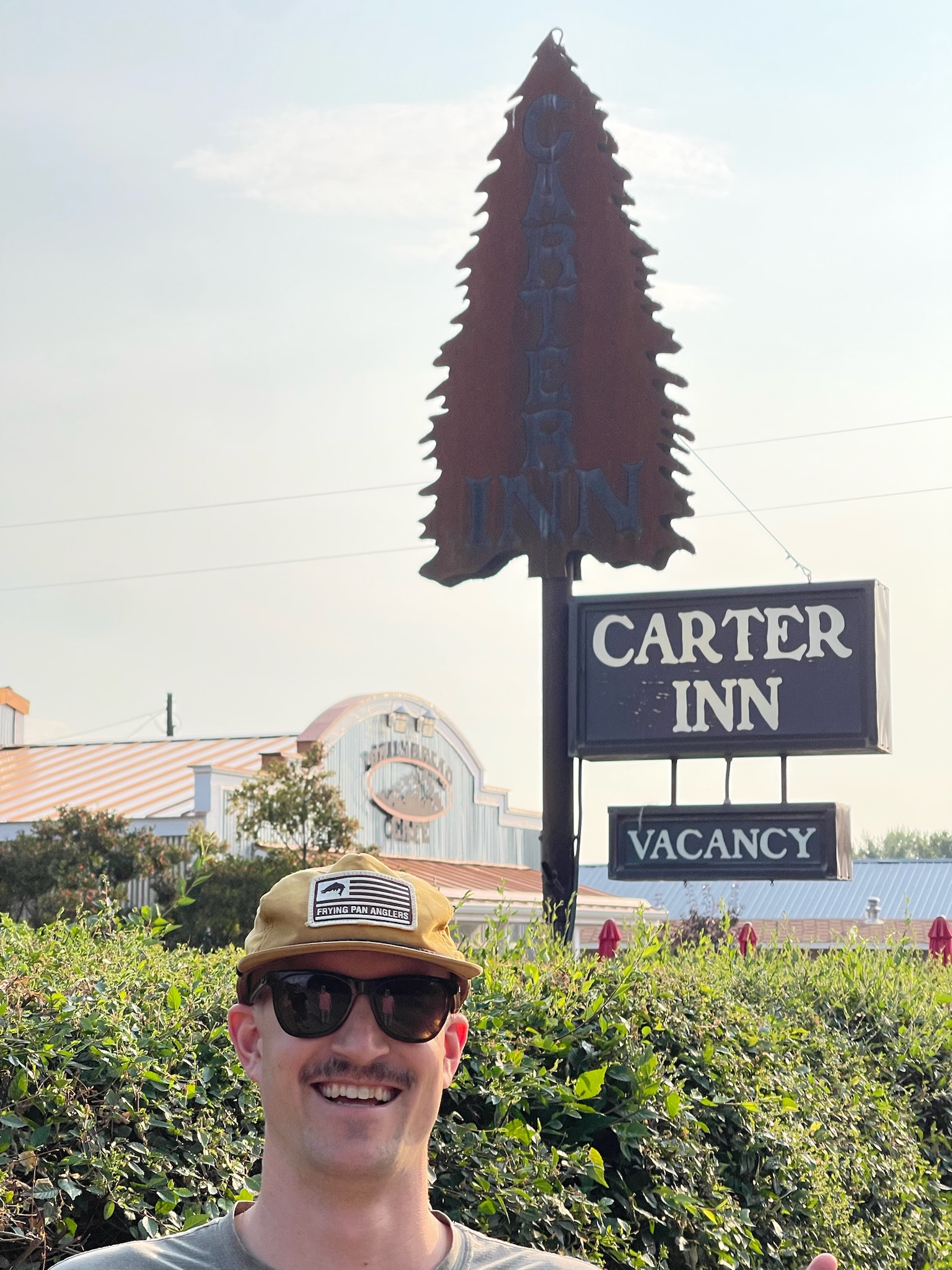 Cheesing in front of the Carter Inn sign - my namesake